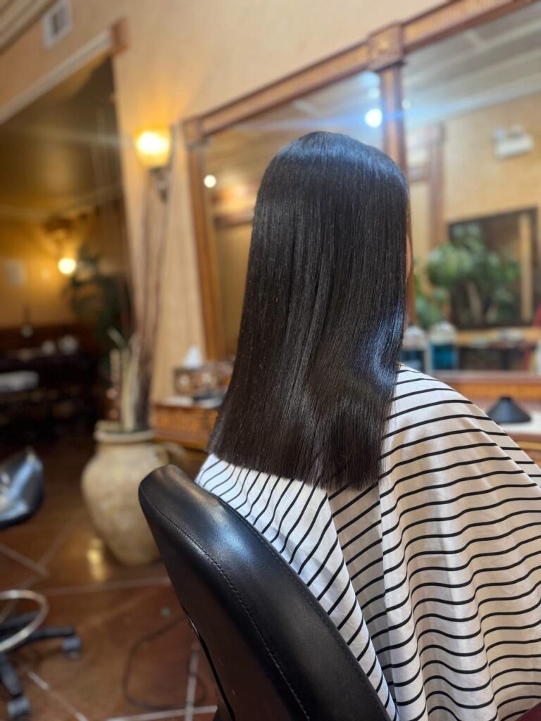 Rich dark hair color with a sleek finish